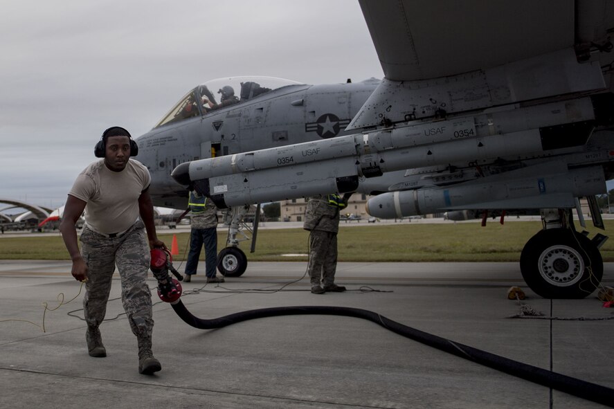 Airman 1st Class Ramauro Bey, 23d Logistics Readiness Squadron fuels distribution operator, retreats from refueling an A-10C Thunderbolt II during a hot-pit refuel, Dec. 8, 2017, at Moody Air Force Base, Ga. Team Moody uses this style of refueling to eliminate the need of extra maintenance and to extend pilot’s training time per flight. (U.S. Air Force photo by Senior Airman Daniel Snider)