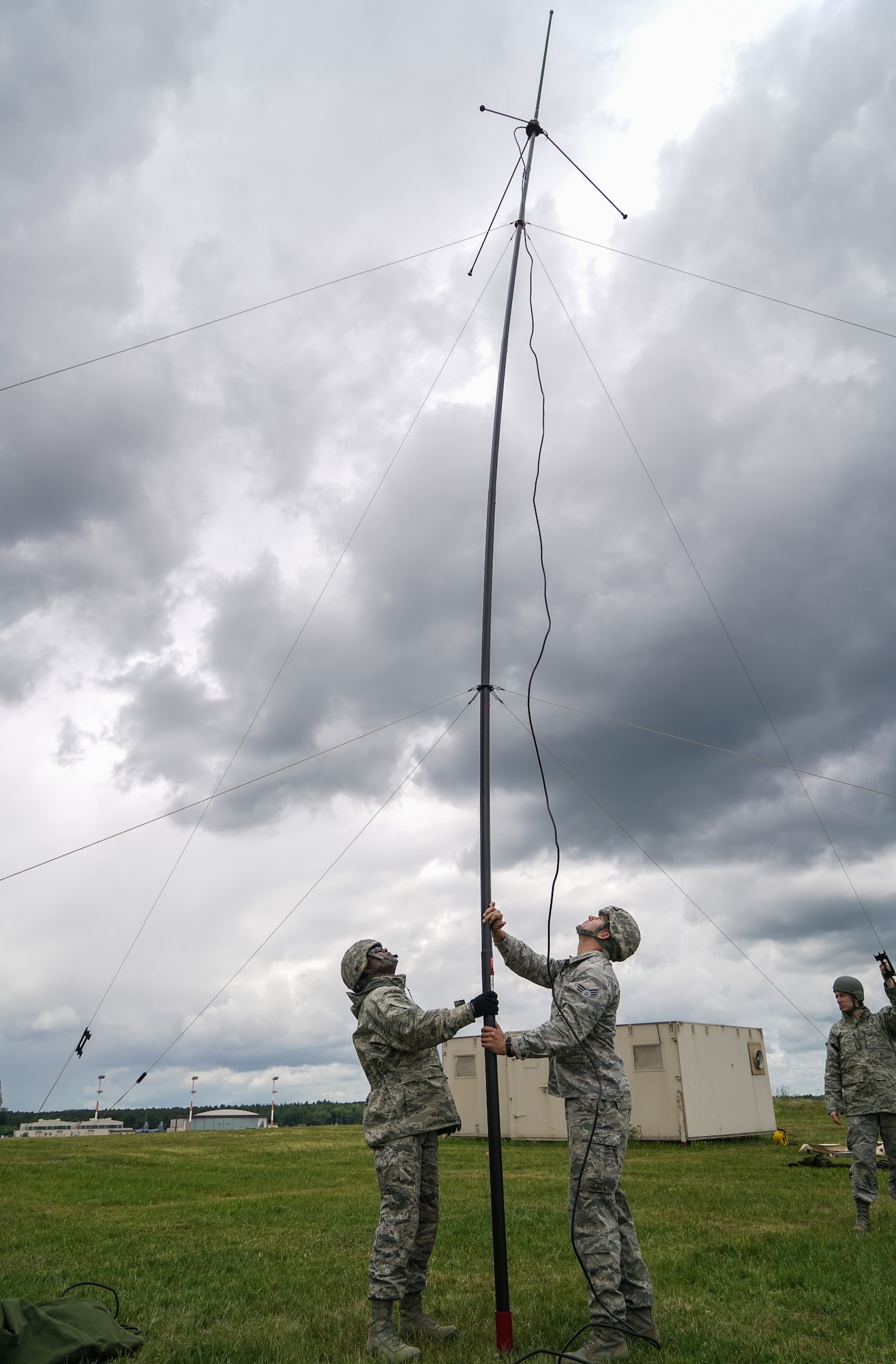 U.S. Air Force Master Sgt. Columbus Cook, an operations technician with the 116th Air Control Wing (ACW), 116th Civil Engineer Squadron (CES), Georgia Air National Guard (GANG), and Senior Airman John Rosales, with the 786th CES, Ramstein Air Base, Germany, raise a tactical communications antenna during United States Air Forces Europe (USAFE) Silver Flag 2017 at Ramstein Air Base, Germany, June 7, 2017. A team 41 GANG civil engineers from the 116th ACW are participating in USAFE Silver Flag 2017.