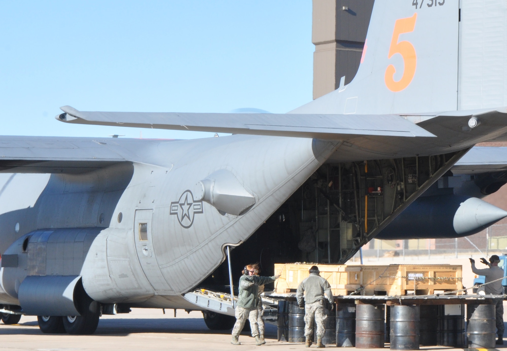 Aerial port Airmen demonstrate the “method B” offload during the loadmaster refresher training Nov. 18 at Peterson Air Force Base, Colorado. The method allows C-130 aircraft to offload two or more connected pallets in an austere location. (U.S. Air Force photo/Daniel Butterfield)
