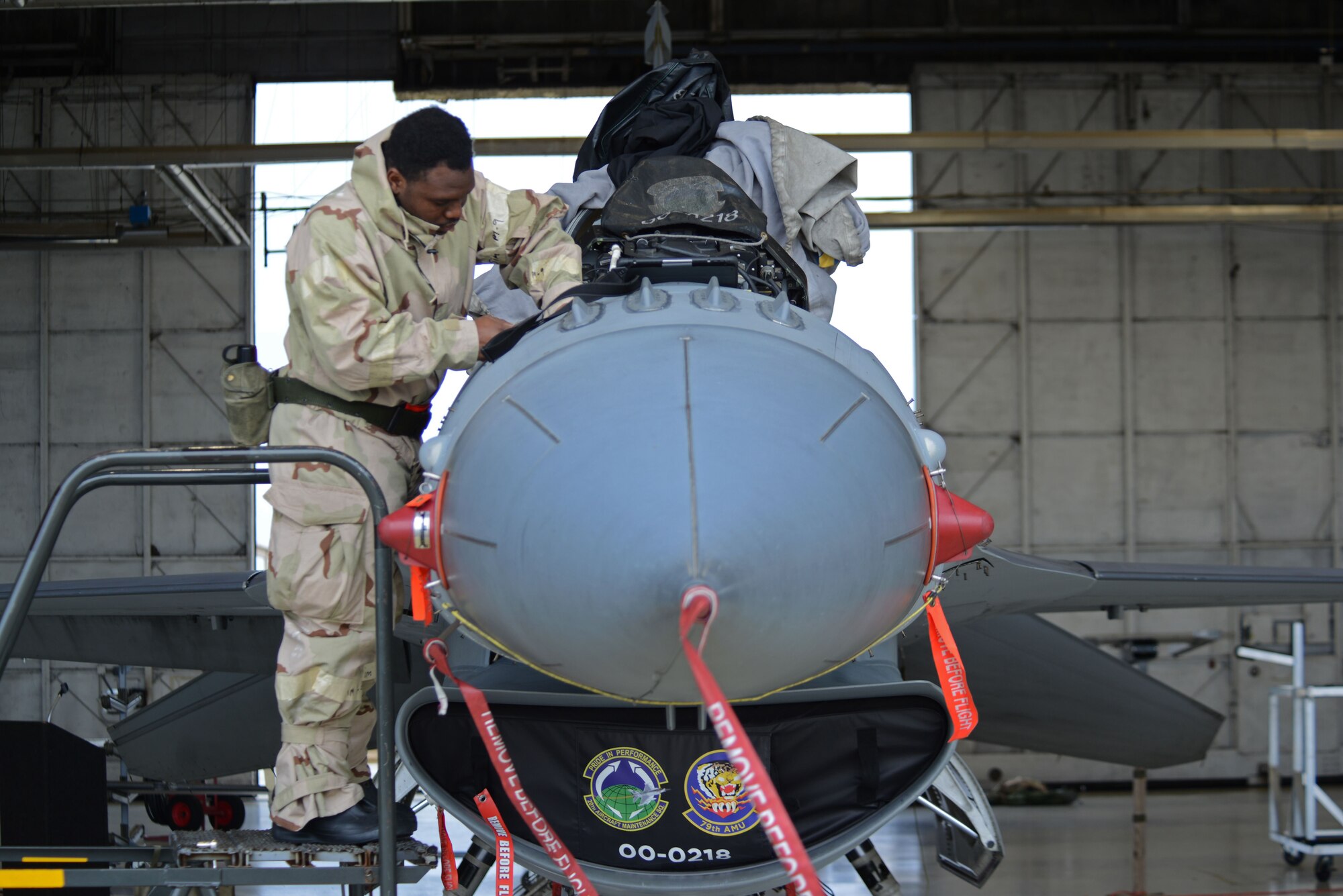 U.S. Air Force Senior Airman Daniel Wallace, 20th Aircraft Maintenance Squadron, 79th Aircraft Maintenance Unit avionics technician, works on an F-16CM Fighting Falcon while under to the Rapid Ready Weasel exercise’s mission-oriented protective posture gear levels at Shaw Air Force Base, S.C., Dec. 7, 2017.