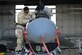 U.S. Air Force Senior Airman Daniel Wallace, 20th Aircraft Maintenance Squadron, 79th Aircraft Maintenance Unit avionics technician, works on an F-16CM Fighting Falcon while under to the Rapid Ready Weasel exercise’s mission-oriented protective posture gear levels at Shaw Air Force Base, S.C., Dec. 7, 2017.