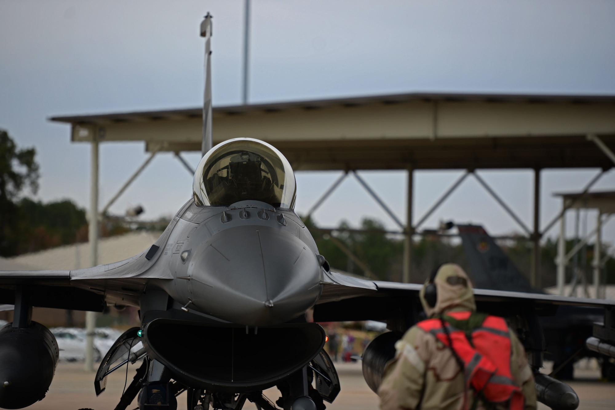 U.S. Air Force Tech. Sgt. Joseph Collett, 20th Aircraft Maintenance Squadron, 79th Aircraft Maintenance Unit flightline expeditor, taxis an F-16CM Fighting Falcon at Shaw Air Force Base, S.C., Dec. 7, 2017.