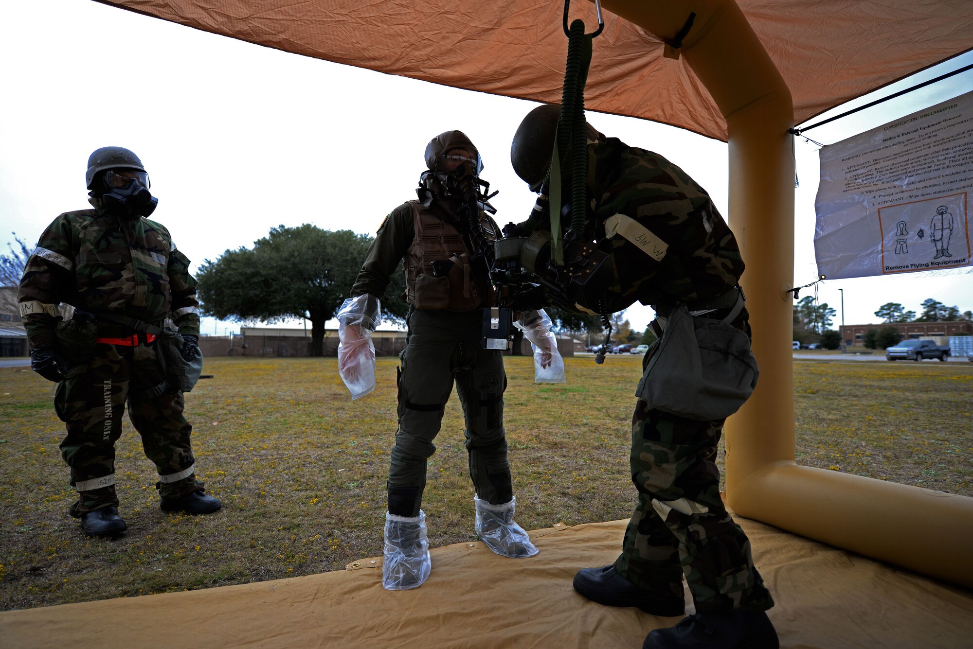 U.S. Air Force Airman 1st Class Jordan Sikes, 20th Aircraft Maintenance Squadron, 79th Aircraft Maintenance Unit aircrew flight equipment technician, simulates decontaminating 1st Lieutenant Robert Grochalski, 79th Fighter Squadron pilot, at Shaw Air Force Base, S.C., Dec. 7, 2017.