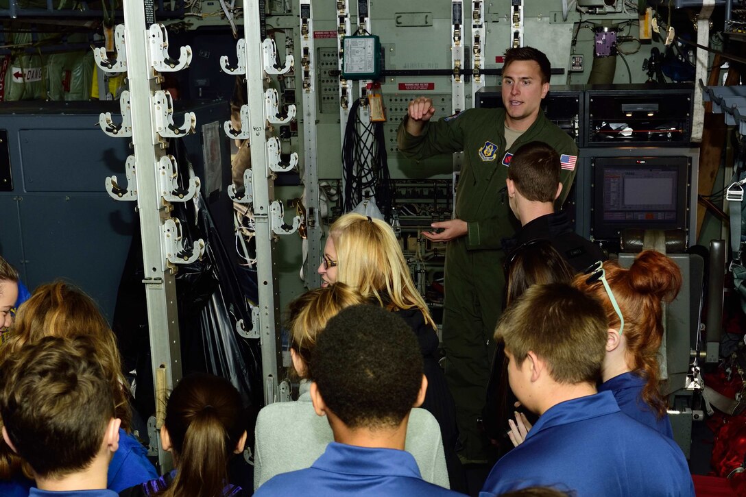 Staff Sgt. Nathan Calloway, 53rd Weather Reconnaissance Squadron weather reconnaissance loadmaster, talks about the 53rd WRS “Hurricane Hunters” mission to students and teachers from Courtney Christian School out of Hammond, Alabama, Dec. 12, 2017, at Keesler Air Force Base, Mississippi. The school group toured one of the squadron’s WC-130J Super Hercules aircraft and visited the 41st Aerial Port Squadron to learn about how they support the flying missions of the 53rd WRS and the 815th Airlift Squadron. (U.S. Air Force photo by Tech. Sgt. Ryan Labadens)