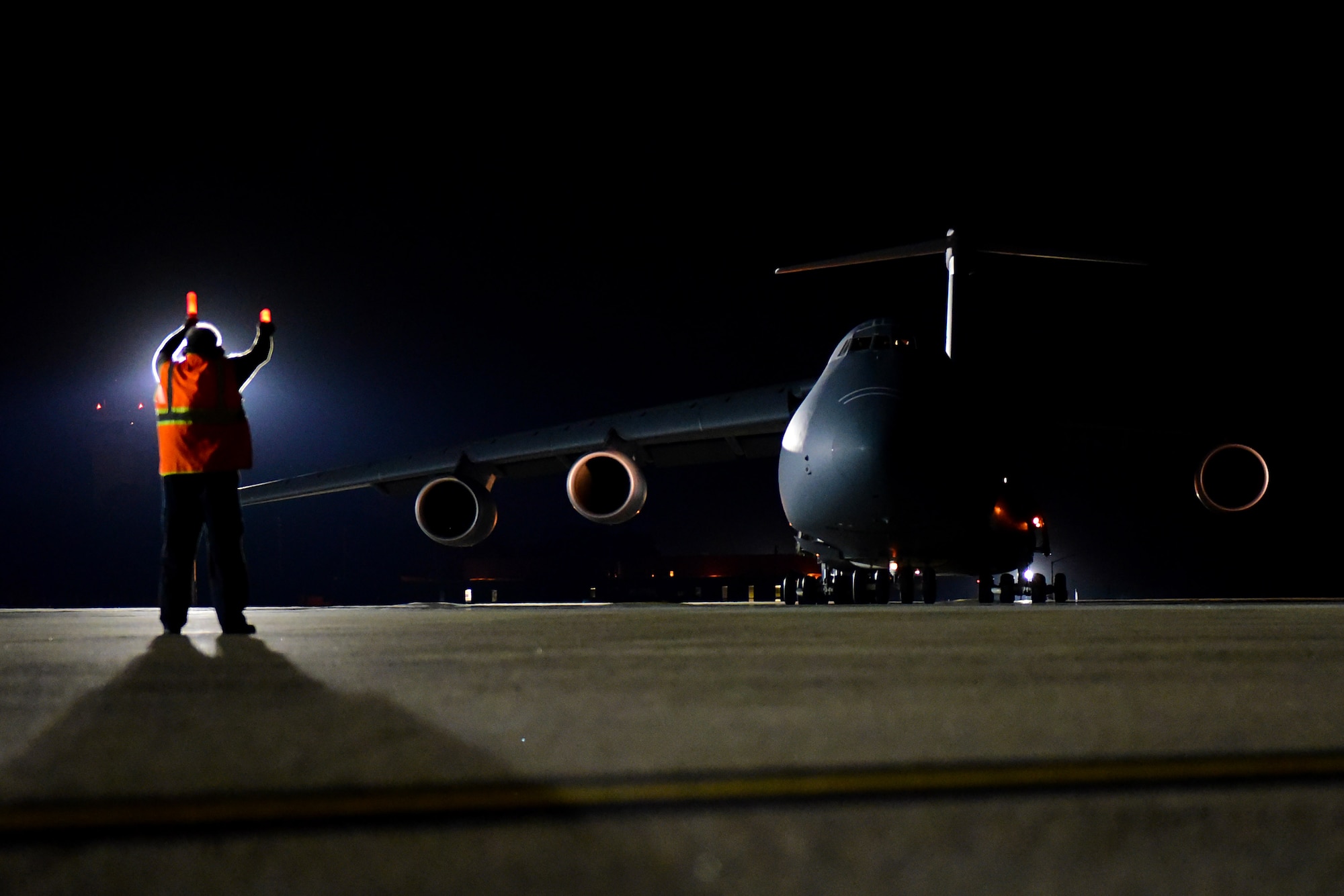 Eddie Holmes, 4th Equipment Maintenance Squadron transit alert aircraft servicer, marshals a taxiing C-5M Super Galaxy, Sept. 29, 2017, at Seymour Johnson Air Force Base, North Carolina. The Super Galaxy is assigned to Dover Air Force Base, Delaware. (U.S. Air Force photo by Airman 1st Class Victoria Boyton)