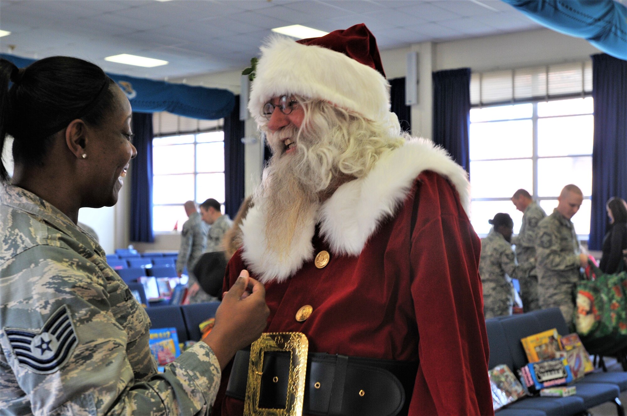 Tech. Sgt. Danita Jones, 111th Force Support Squadron human resources technician, greets Santa Claus during a holiday event for military families Dec. 2, 2017, at Horsham Air Guard Station, Pa. Retired Chief Master Sgt. Richard Mertz, formerly a member of the 111th FSS, played Santa for the military children at the event, listening to their wish lists and posing for photos. (U.S. Air National Guard photo by Tech. Sgt. Andria Allmond)