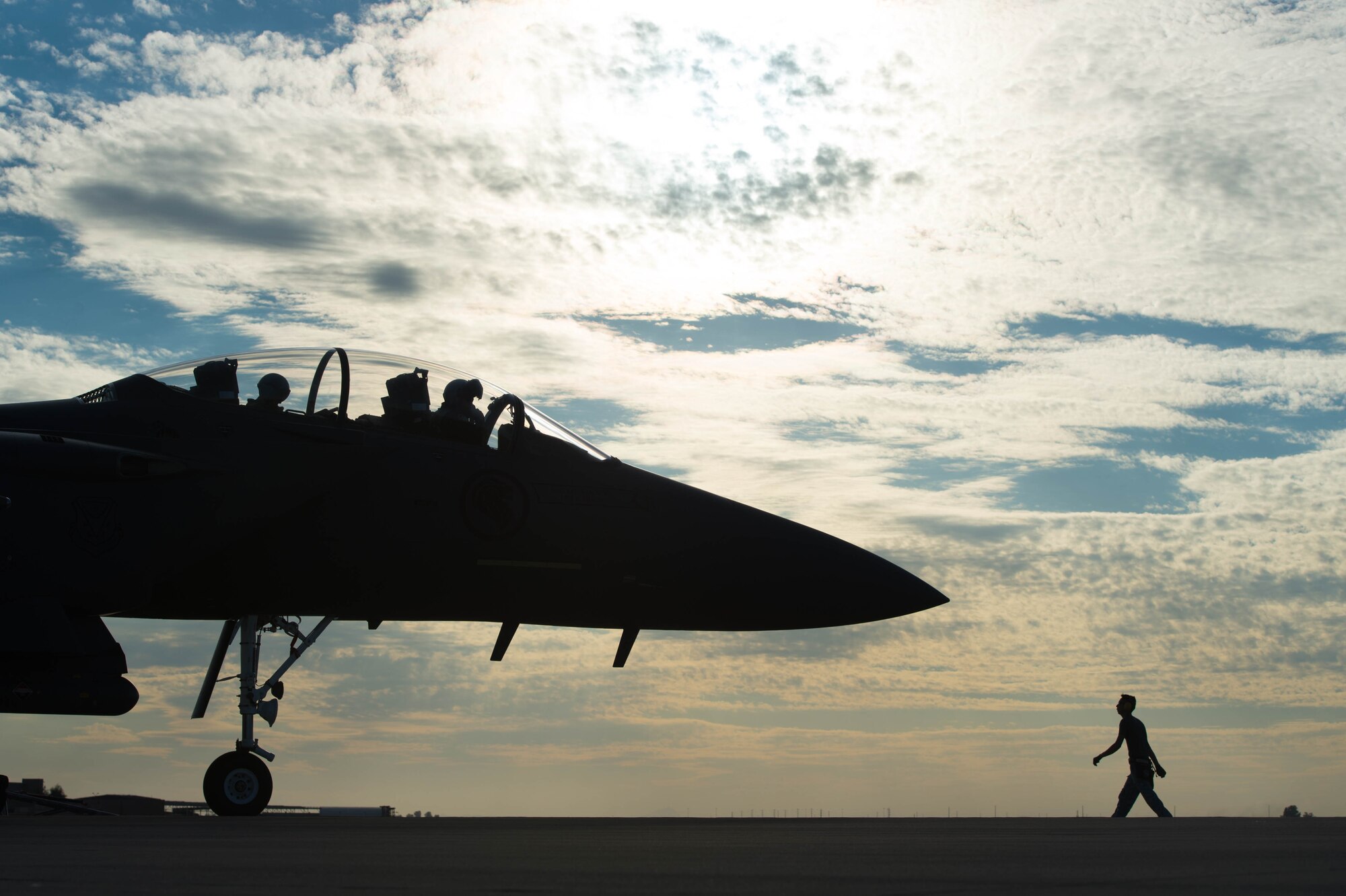A Republic of Singapore Airman walks near an F-15SG Eagle, assigned to the 428th Fighter Squadron, at Luke Air Force Base, Ariz., Dec. 2, 2017. The 428th FS, from Mountain Home Air Force Base, Idaho, participated in joint training that required sorties throughout the day and night. (U.S. Air Force photo/ Staff Sgt. Jensen Stidham)