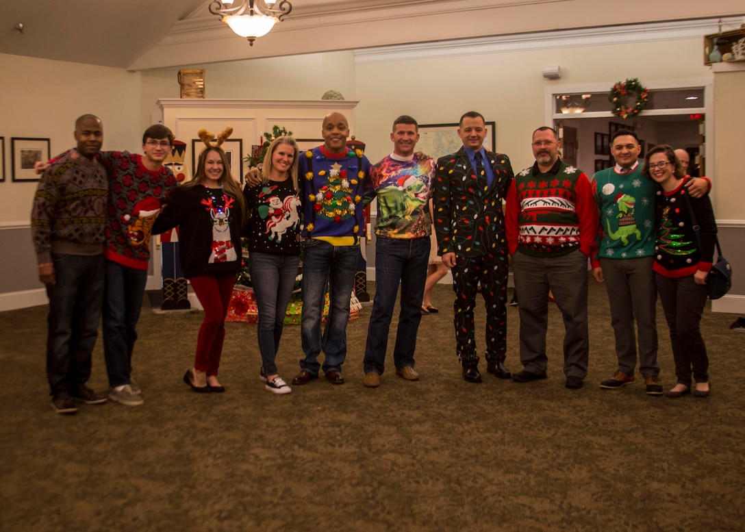 Participants of the 6th Marine Corps District (6MCD) ugly sweater contest pose for a group photo during the 6MCD Holiday Party aboard Marine Corps Recruit Depot Parris Island, South Carolina, Dec. 12, 2017. The party gave the families of 6MCD the opportunity to build comradery through holiday celebration. (U.S. Marine Corps photo by Lance Cpl. Jack A. E. Rigsby)