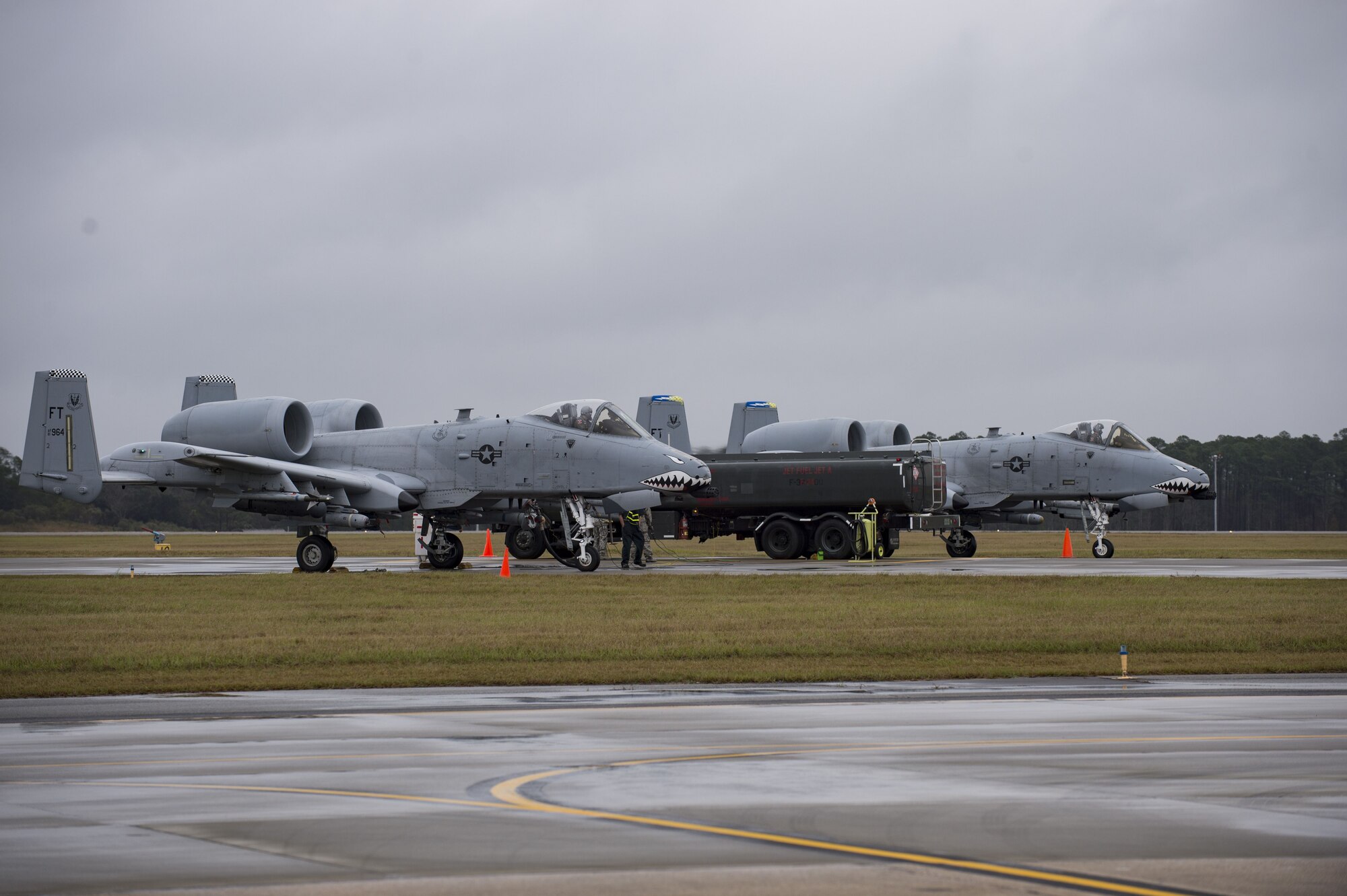 Airmen from the 23d Logistics Readiness Squadron preform a hot pit refuel on A-10C Thunderbolt IIs, Dec. 7, 2017, at Moody Air Force Base, Ga. Moody recently participated in a week-long, Phase 1, Phase 2 exercise designed to demonstrate the 23d Wing’s ability to meet combatant commander objectives. The exercise tested LRS Airmen on hot pit refueling, a procedure usually performed in a combat situation to rapidly refuel aircraft. 
 (U.S. Air Force photo by Andrea Jenkins)