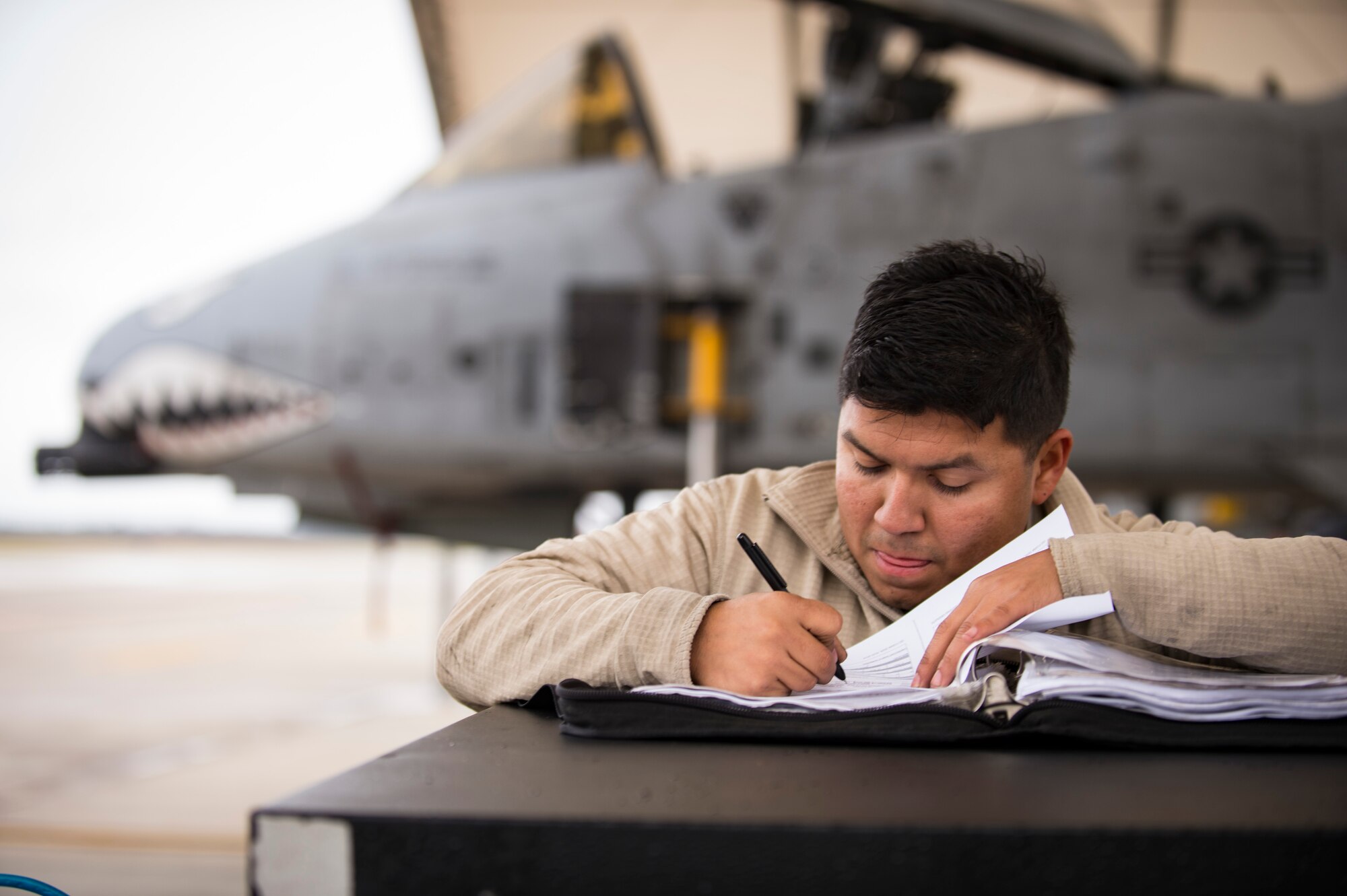 A crew chief documents maintenance performed on a A-10C Thunderbolt II during a thru flight inspection, Dec. 7, 2017, at Moody Air Force Base, Ga. Moody recently participated in a week-long, Phase 1, Phase 2 exercise designed to demonstrate the 23d Wing’s ability to meet combatant commander objectives. The exercise tested pilots’ and maintainers’ ability to launch around-the-clock sorties at an accelerated rate during surge operations. (U.S. Air Force photo by Andrea Jenkins)