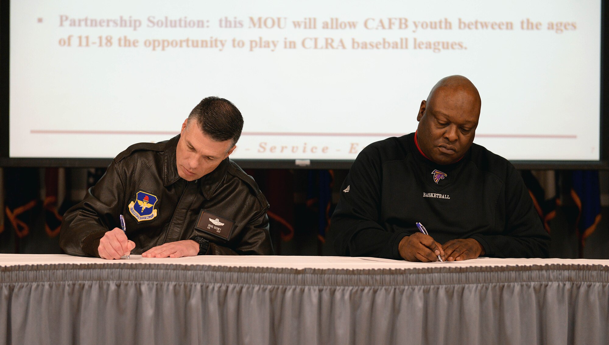 Col. Douglas Gosney, 14th Flying Training Wing Commander, and Greg Lewis, Columbus-Lowndes Recreation Authority Director, sign a memorandum of understanding Dec. 12, 2017, on Columbus Air Force Base, Mississippi. This MOU provides the framework for Columbus AFB youth between the ages of 11 to 18 years old to be able to participate in CLRA baseball leagues. This is often needed due to the small youth population on the base. This was one of 16 areas explored during the Air Force Community Partnership meeting. (U.S. Air Force photo by Airman 1st Class Keith Holcomb)