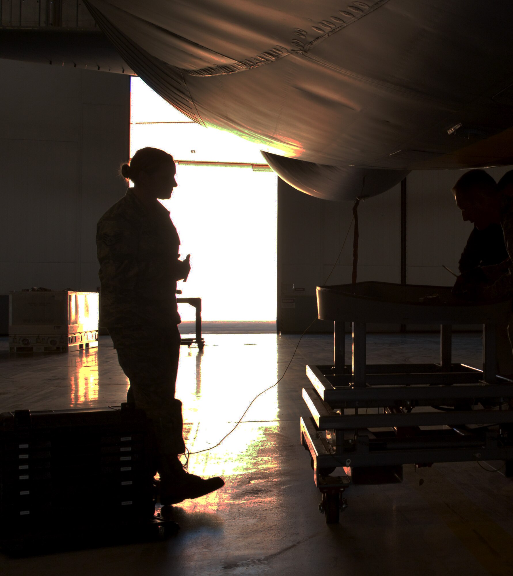 Staff Sgt. Kirsten Milkowski, 507th Aircraft Maintenance avionics technician, walks toward her team members during the installation of the Large Aircraft Infrared Countermeasures pod onto a KC-135 Oct. 25, 2017 at Tinker Air Force Base, Okla. (U.S. Air Force photo/Tech. Sgt. Samantha Mathison)