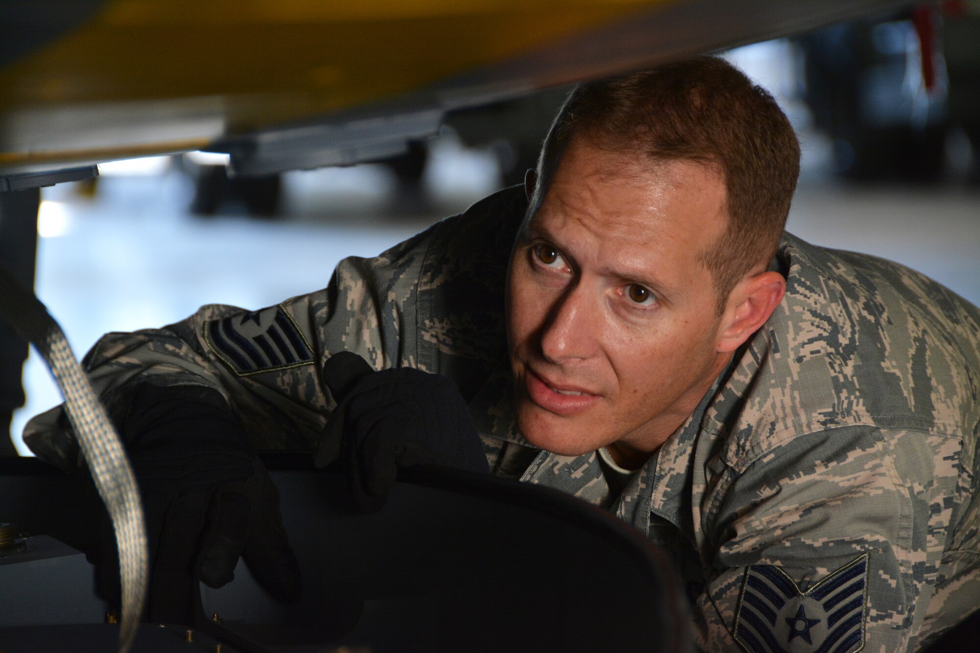 Tech. Sgt. Eric Harmon, 507th Aircraft Maintenance Squadron avionics technician, inspects the area of the KC-135 where the Large Aircraft Infrared Countermeasures pod attaches to the underside of the aircraft Oct. 25, 2017, at Tinker Air Force Base, Okla. (U.S. Air Force photo/Tech. Sgt. Samantha Mathison)