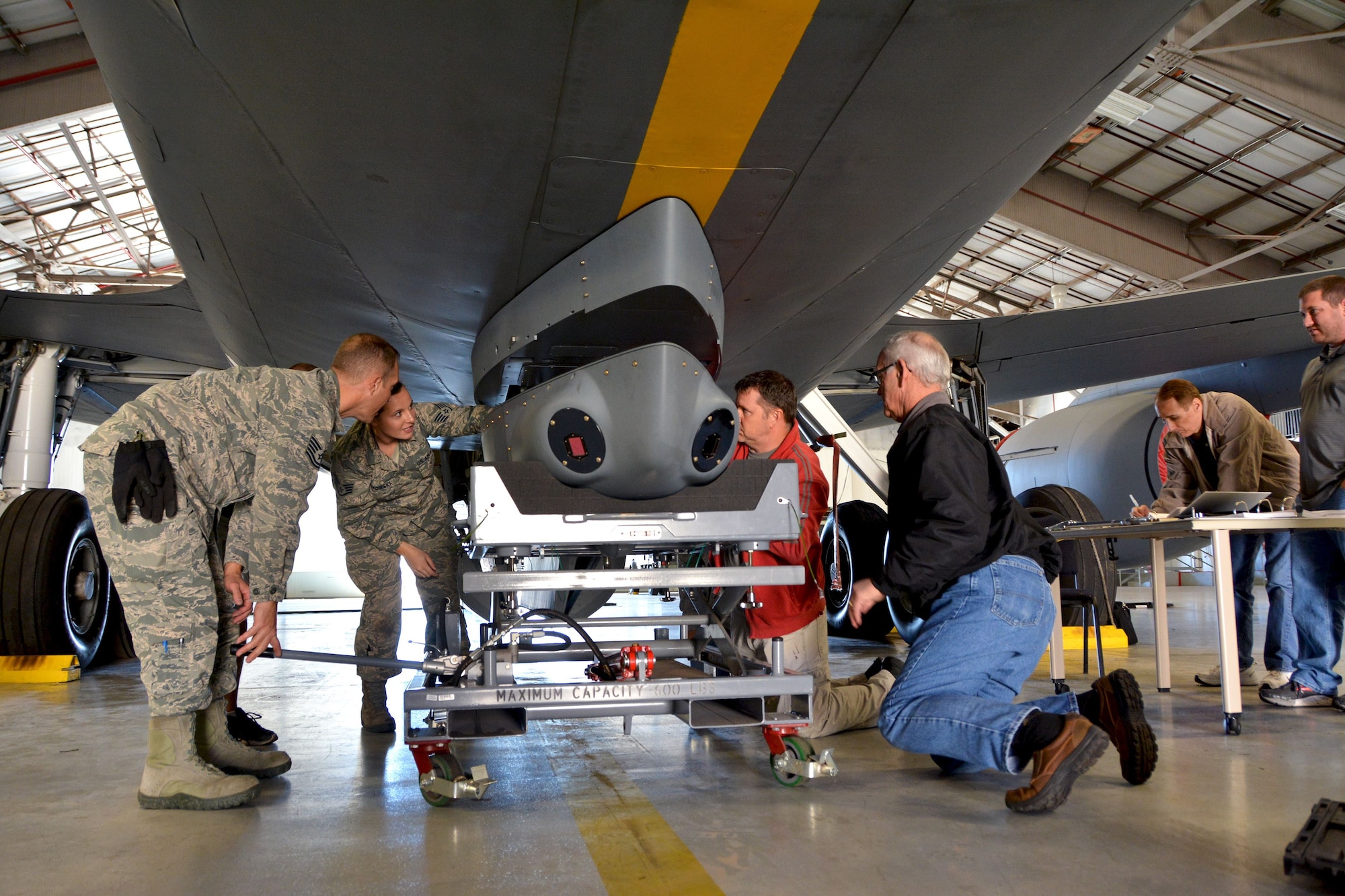 A 507th Air Refueling Wing aircraft maintenance team installs a Large Aircraft Infrared Countermeasures pod onto the underside of a KC-135 Stratotanker Oct. 25, 2017 at Tinker Air Force Base, Okla. (U.S. Air Force photo/Tech. Sgt. Samantha Mathison)
