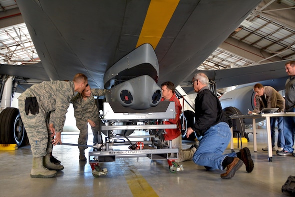 A 507th Air Refueling Wing aircraft maintenance team installs a Large Aircraft Infrared Countermeasures pod onto the underside of a KC-135 Stratotanker Oct. 25, 2017 at Tinker Air Force Base, Okla. (U.S. Air Force photo/Tech. Sgt. Samantha Mathison)