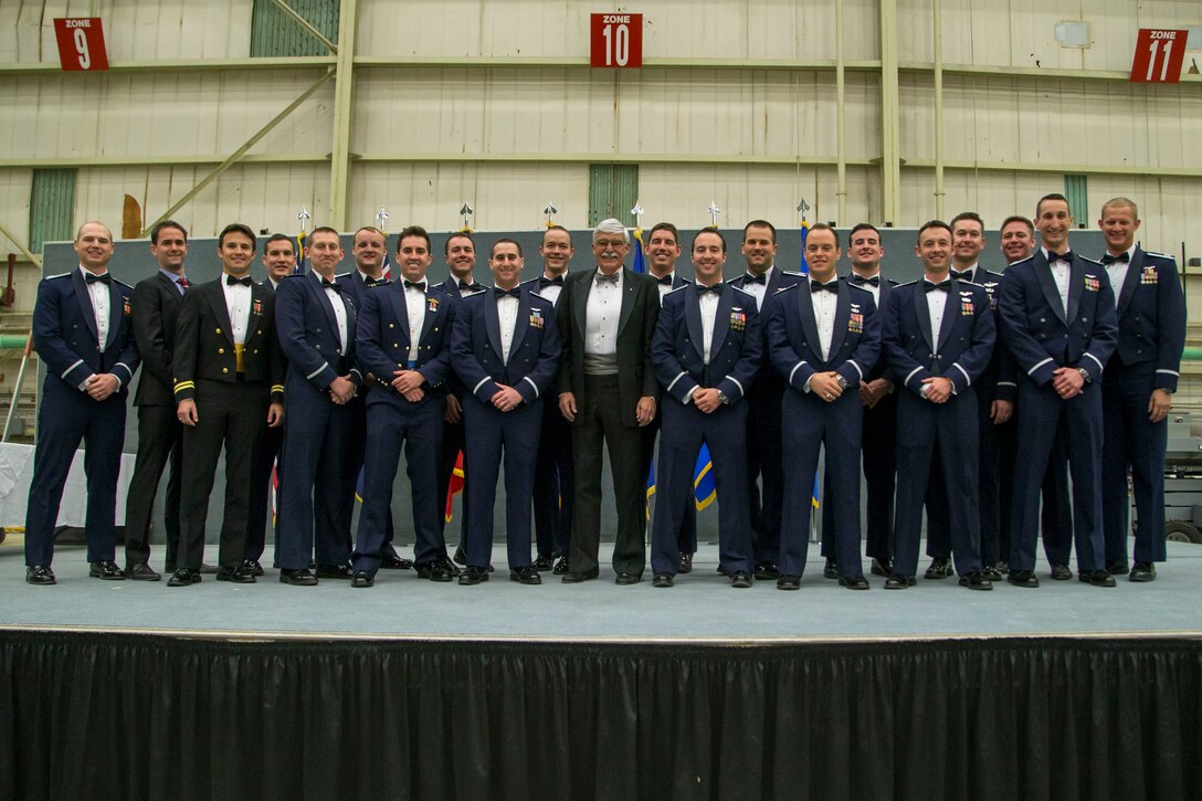 U.S. Air Force Test Pilot School Class 17A pose for a group photo on the graduation stage in Hangar 1623 Dec. 8. (U.S. Air Force photo by Ethan Wagner)