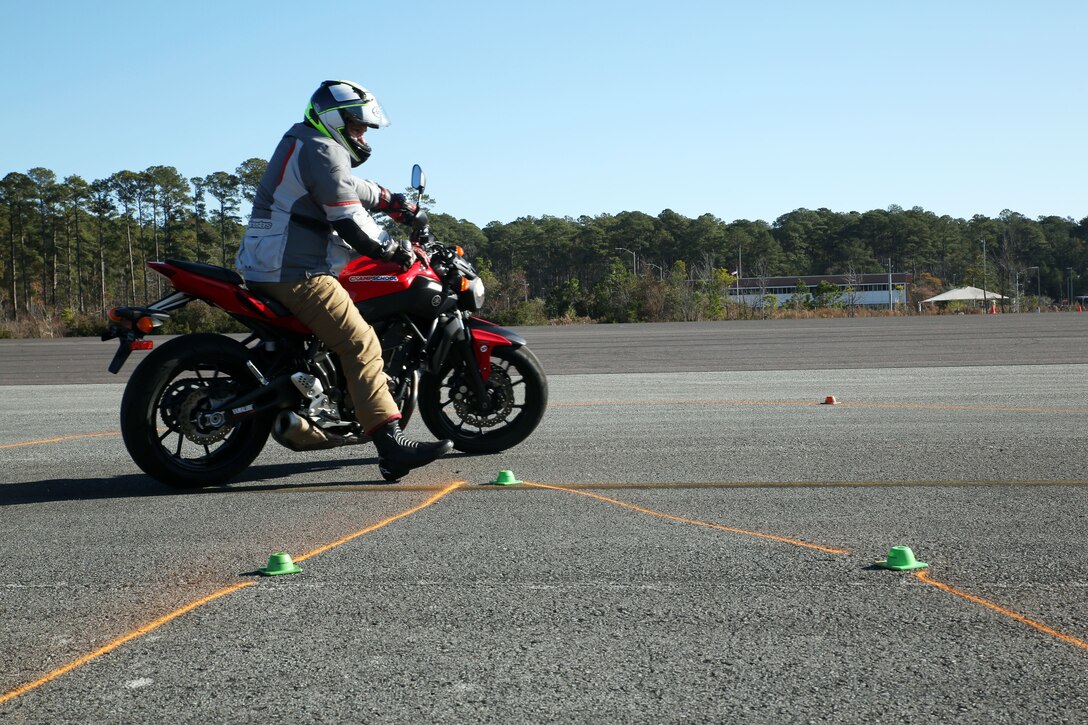 Bill Sink demonstrates a tight turn on a motorcycle training course during a level III motorcylce riders class aboard Marine Corps Air Station Cherry Point, N.C., Dec. 11, 2017. The course was part of the level III motorcycle rider training. Sink is a course instructor. (U.S. Marine Corps photo by Pfc. Andrew King/ Released)