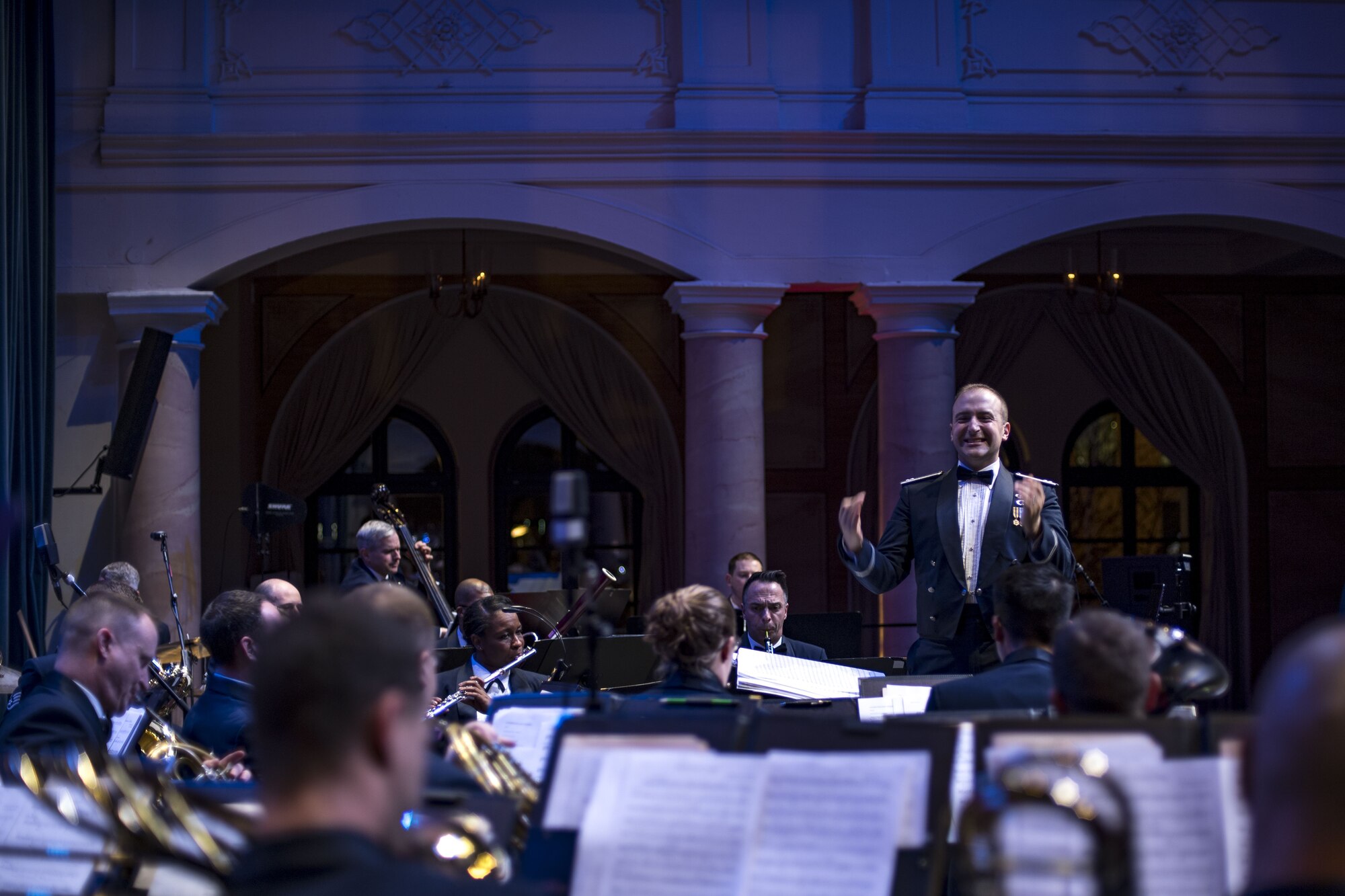 U.S. Air Force Capt. Justin Lewis, United States Air Forces in Europe Band flight commander and associate conductor, directs the USAFE Band during a Christmas concert at Fruchthalle in Kaiserslautern, Germany, Dec. 8, 2017. USAFE Band held the concert to bolster relationships between the U.S. military community and the local community. (U.S. Air Force photo by Senior Airman Devin Boyer)