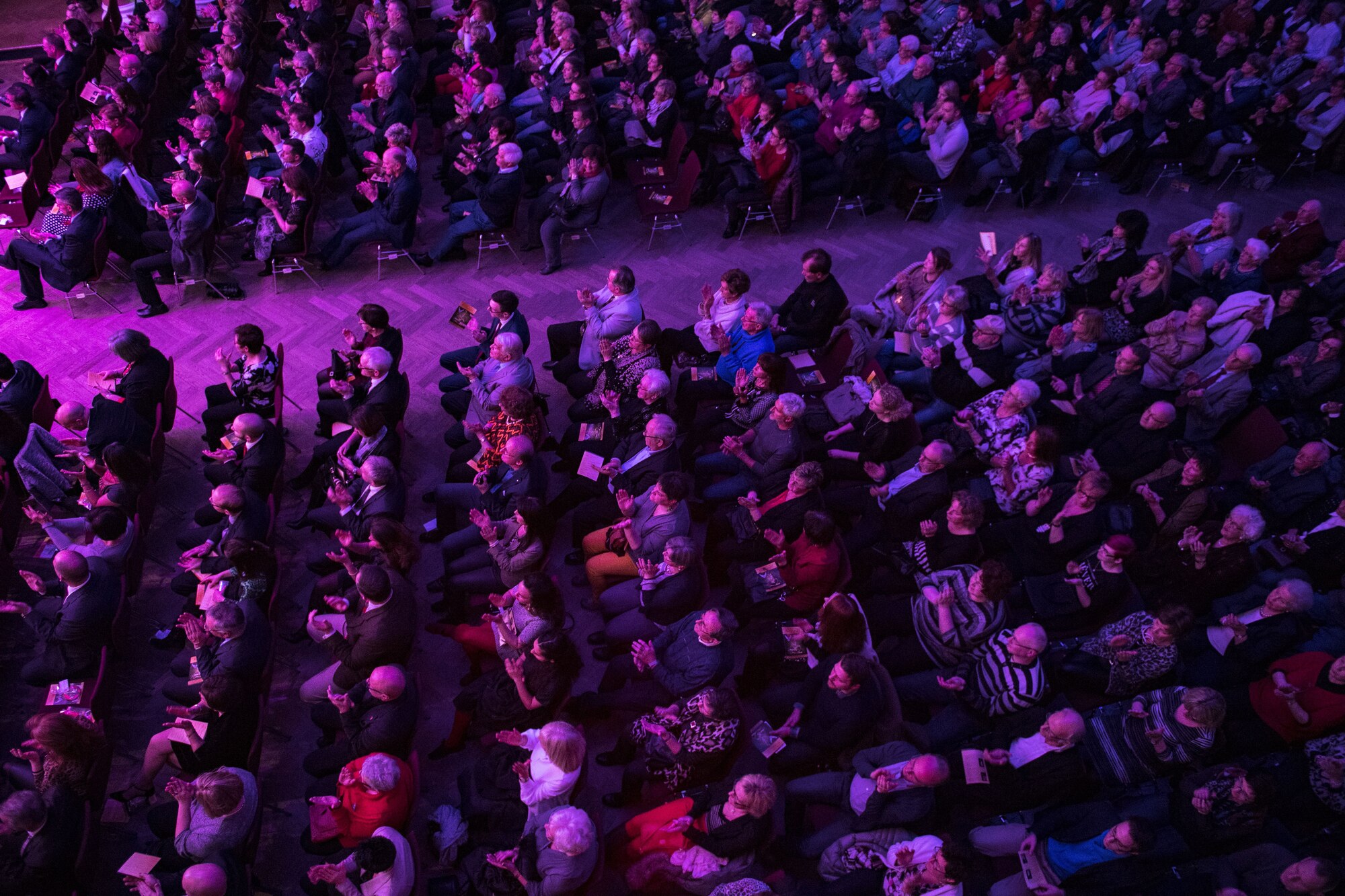 Local community members appluad after the United States Air Forces in Europe Band performed a Christmas song during a concert at Fruchthalle in Kaiserslautern, Germany, Dec. 8, 2017. USAFE Band held the concert to bolster relationships between the U.S. military community and the local community. (U.S. Air Force photo by Senior Airman Devin Boyer)
