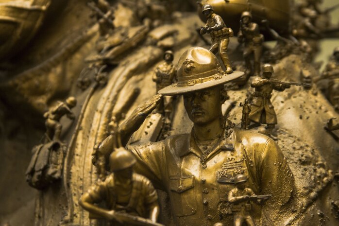 A drill instructor figurine, part of a much larger statue, holds a steady salute on its day of unveiling at the National Marine Corps Museum in Triangle, Virginia, Dec. 13, 2017. At Their Core, one of three statutes that were unveiled, was crafted by Kris Kuksi for Marine Corps Recruiting Command’s Battles Won brand idea, but also to represent the irreducible fighting spirit of Marines. Kuksi is an artist contracted to work with MCRC's contracted advertisement agency, J. Walter Thompson.