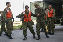 Japan Ground Self Defense Force soldiers with Medical Department, Ground Staff Office, Western Army, attend to a simulated casualty during a mass-casualty scenario Dec. 12, 2017, at Camp Naha, Okinawa, Japan. U.S. medical personnel from 3rd Medical Battalion, 3rd Marine Logistics Group, U.S. Marine Corps, U.S. Naval Hospital Okinawa and 18th Medical Group, 18th Wing Support Squadron, U.S. Air Force were invited to Camp Naha during the Japanese and U.S. Medical Expert Exchange Event training to learn more about each service’s medical training, tactics and procedures. (U.S. Marine Corps photo by Sgt. Tiffany Edwards)