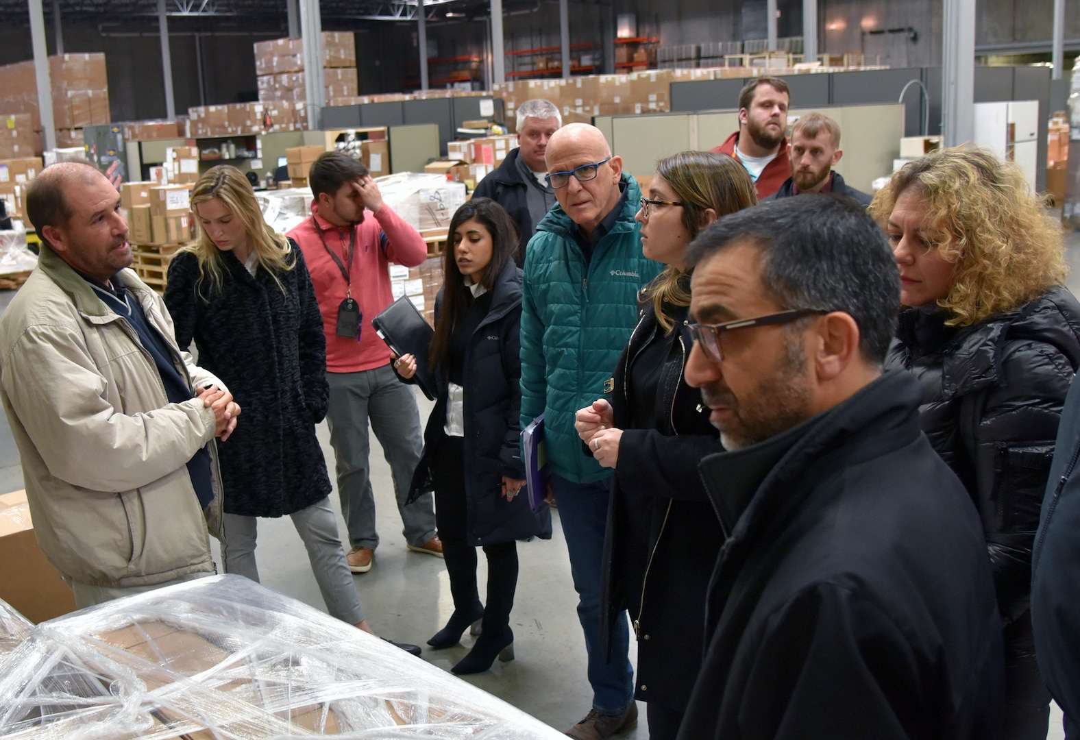 Jay Lightner, supervisor, DLA Unit Materiel Fielding Point, provides information on the distribution process of FMS material to the Israel Security Assistance Liaison Officers during their visit to the storage area.