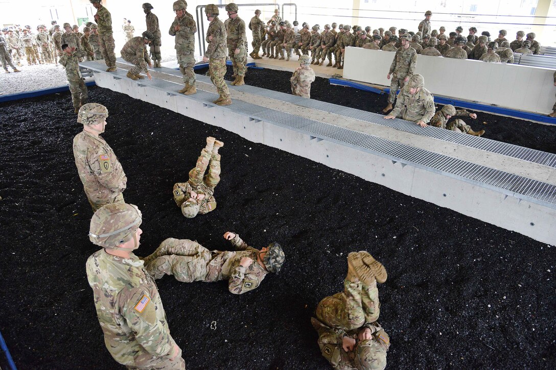 Soldiers roll on the ground.