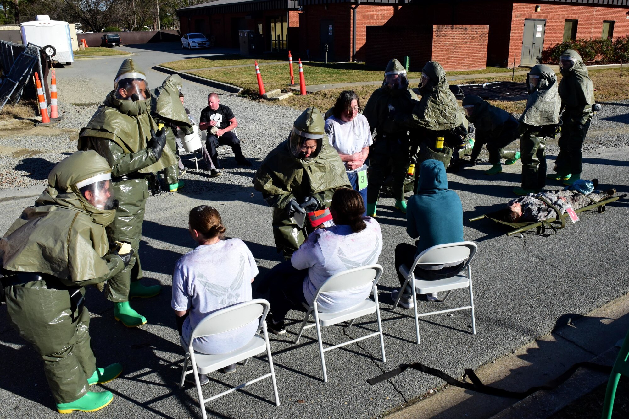 Members of the 4th Medical Group decontamination team treat patients covered with simulated biohazard material during a chemical, biological, radiological, nuclear and explosive mass casualty exercise Dec. 13, 2017, at Seymour Johnson Air Force Base, North Carolina.