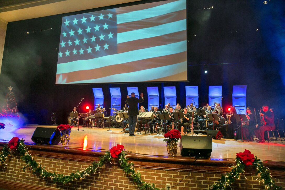 Army Chief Warrant Officer 4 James Bettencourt, commander of the Army Materiel Command's band, directs a performance.