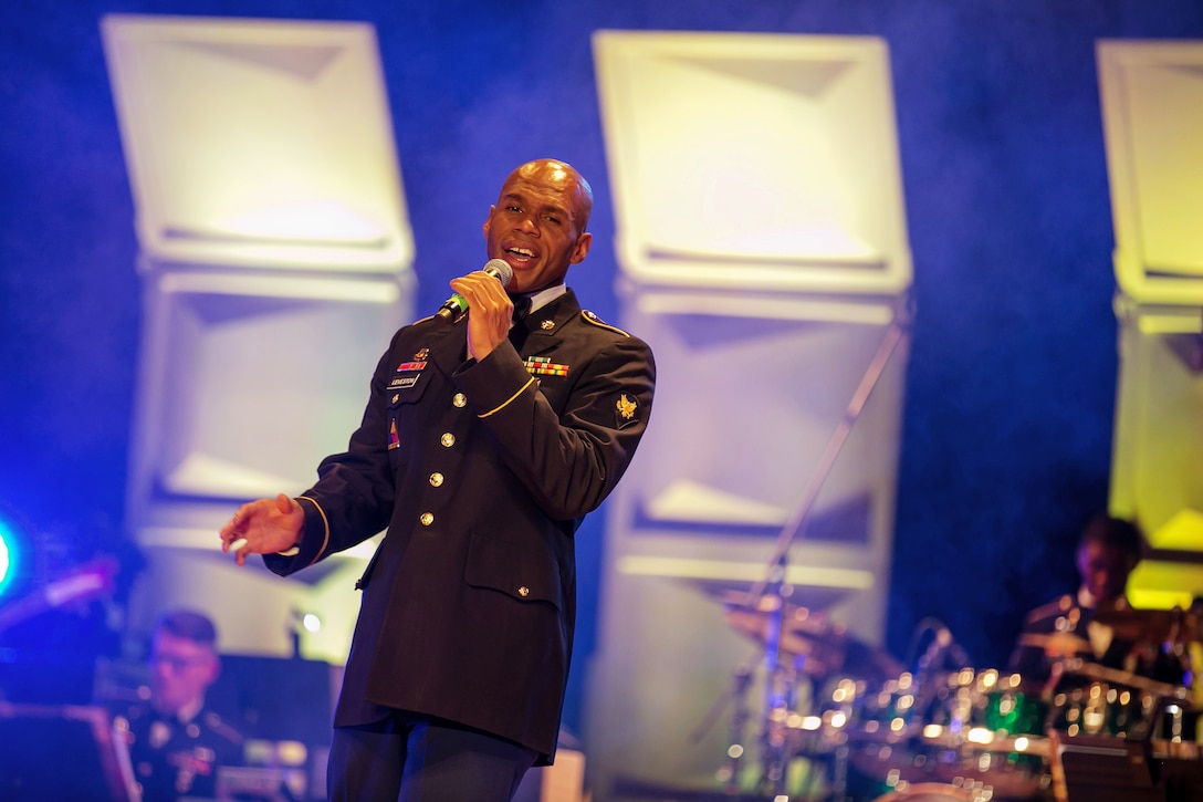 Army Spc. Joseph Leveston sings "Go Tell it on the Mountain", during the Army Materiel Command's band holiday concert.
