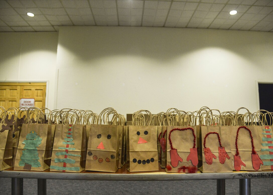 Bags of cookies prepared by the Kirtland Spouses Club wait for distribution at Kirtland Air Force Base, N.M., Dec. 12. More than 65 bakers contributed to the drive, bringing in around 4,700 cookies. The bags were decorated by students from Sandia Elementary School.