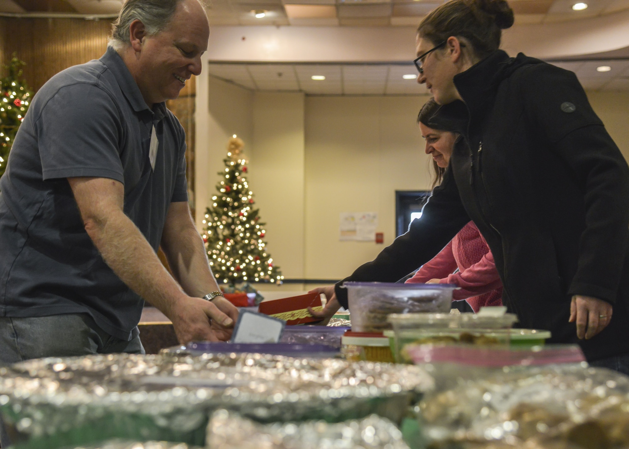 Members of the Kirtland Spouses Club organize and bag cookies during the Kirtland Spouse’s cookie drive at Kirtland Air Force Base, N.M., Dec. 12. More than 65 bakers contributed to the drive, bringing in around 4,700 cookies.