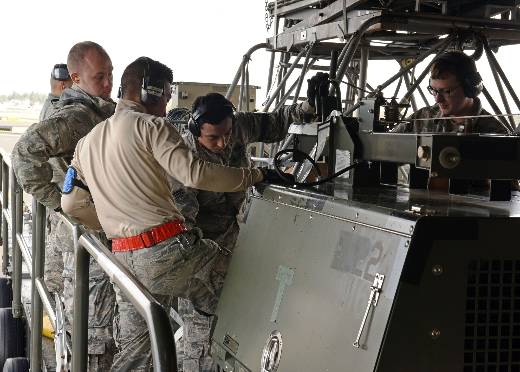 Airmen assigned to the 62nd Aerial Port Squadron prepare to load cargo onto a C-117 Globemaster III as part of a mobility exercise, Dec. 1, 2017 on the McChord Field flightline at Joint Base Lewis-McChord, Wash. The exercise was intended to hone the ability of 62nd Airlift Wing and 627th Air Base Group Airmen to deploy forces and cargo anywhere, anytime utilizing global airlift. (U.S. Air Force photo by Staff Sgt. Whitney Taylor)