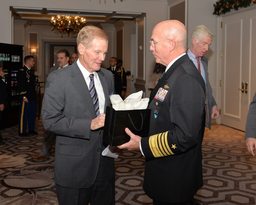 Sen. Bill Nelson accepts a gift from Adm. Kurt Tidd.