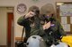 1st Lt. William Utsey, 4th Airlift Squadron pilot, holds his aircrew eye and respiratory protection system in place while a wingman secures his gear for the ability to survive and operate portion of a mobility exercise, Dec. 1, 2017 at Joint Base Lewis-McChord, Wash. Over the course of four days, pilots wore AERPS gear during flight simulations to gauge readiness and sharpen their abilities. (U.S. Air Force photo by Airman 1st Class Sara Hoerichs)
