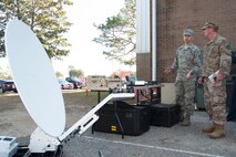 Tech. Sgt. Nathaniel Bohn, 919th Special Operations Communications Squadron, displays components of a satellite deployable node