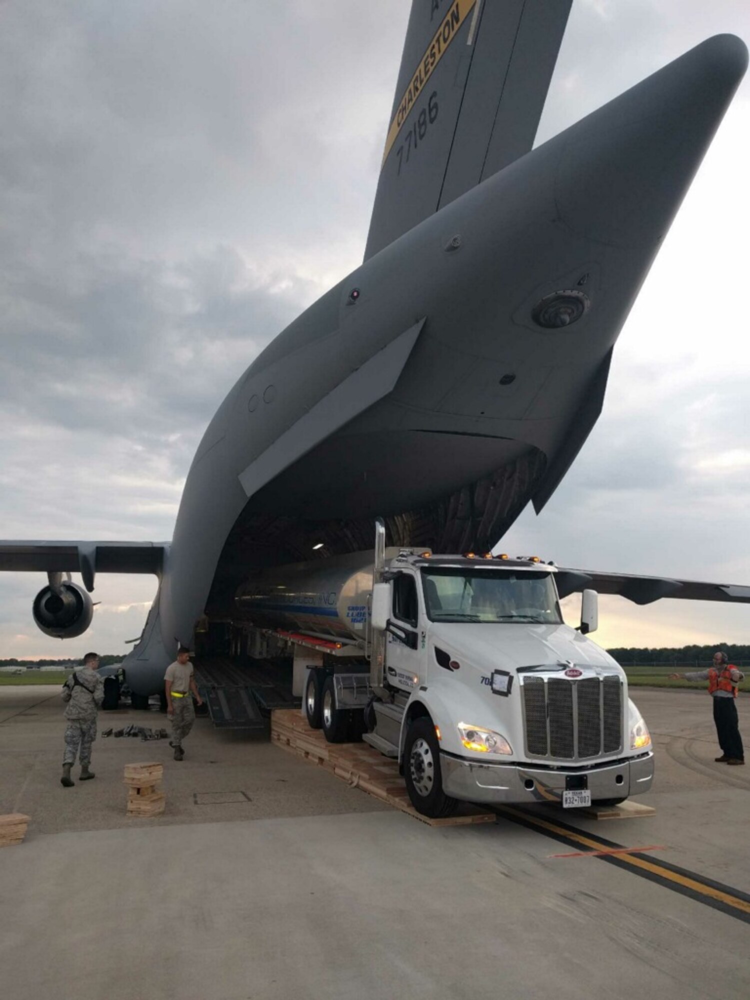 A fuel tank truck is loaded onto a C-17 aircraft, for delivery to Puerto Rico, to assist in the hurricane recovery efforts. The Air Force Life Cycle Management Center’s Air Transportability Test Loading Activity office at Wright-Patterson Air Force Base, ensured the aircraft was able to carry the fuel truck and that it was properly secured. (Courtesy photo)