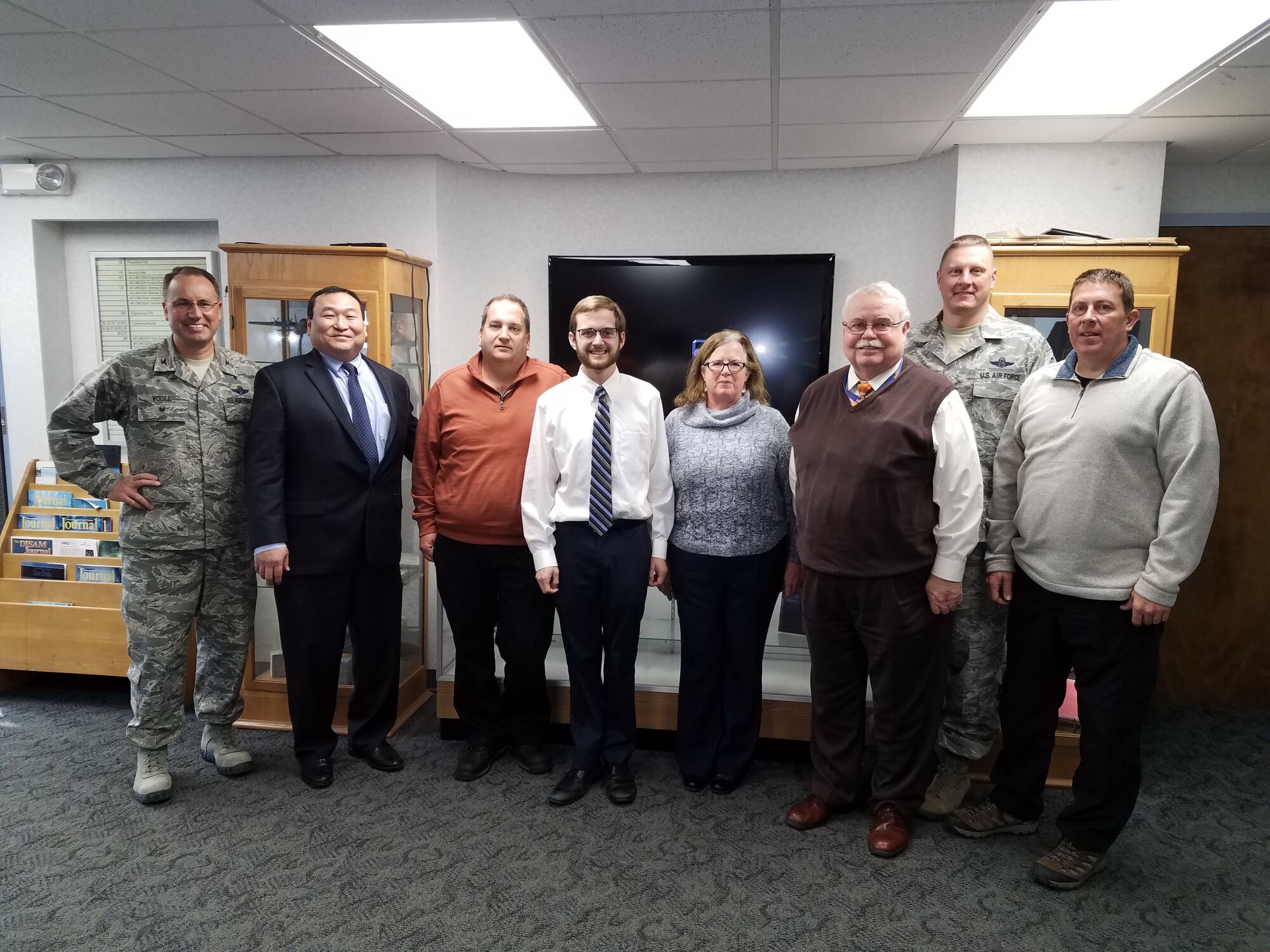 Members of the Air Force Life Cycle Management Center's Air Transportability Test Loading Activity office at Wright-Patterson Air Force Base, were recently recognized by Col. George Vogel (left), chief of the mobility division and director of the North American Aerospace Defense Command/U.S. Northern Command Deployment Distribution Operations Center, for supporting hurricane rescue and recovery efforts in Texas, Florida, Puerto Rico and countries in the Caribbean. (U.S. Air Force photo / Brian Brackens)