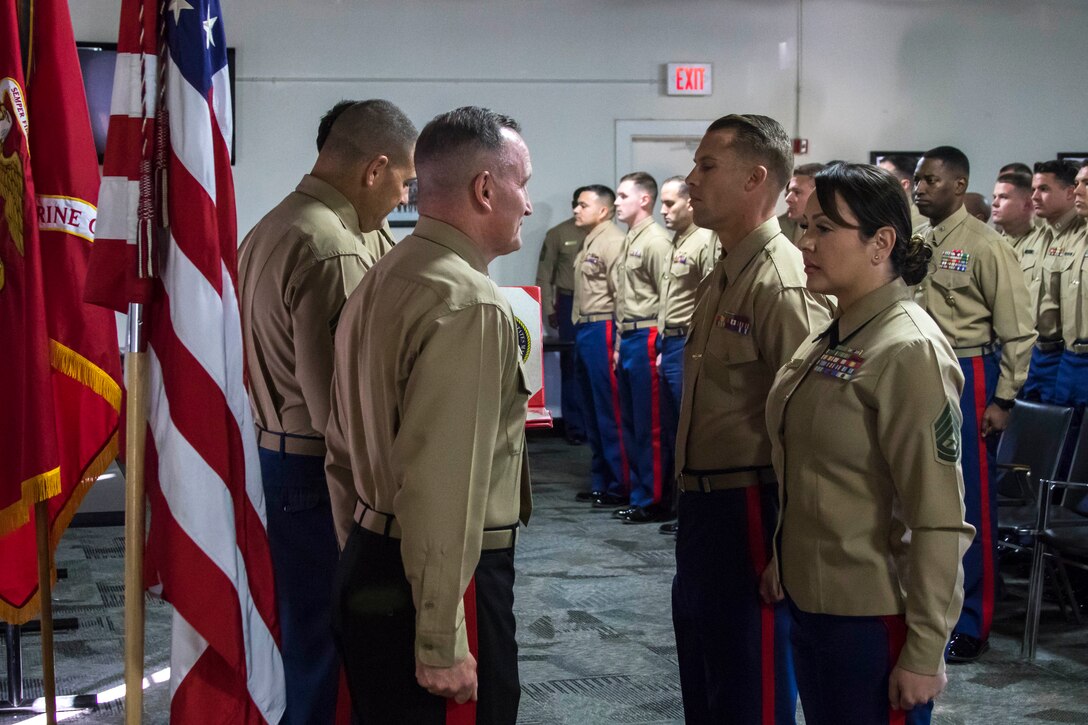U.S. Marine Corps Brig. Gen. William M. Jurney, Commanding General of Marine Corps Recruit Depot (MCRD) San Diego, presents Gunnery Sgt. Shannon Umana, Assistant for Officer Procurement Operations Chief, 12th Marine Corps District, with a Navy and Marine Corps Achievement Medal during the Marine Corps Recruiting Command’s Annual National Officer Selection Officers training seminar aboard MCRD San Diego, Calif., Dec. 12, 2017. The OSOs were recognized for superior achievement in locating, contracting and shipping qualified officer candidates throughout Fiscal Year 2017.
