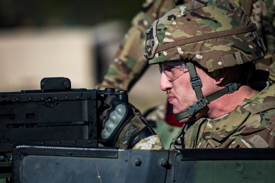 Tech. Sgt. Brian Bond, 823d Base Defense Squadron fireteam member, aims before firing a .50 Caliber M2 machine gun during a heavy weapons qualification, Dec. 13, 2017, at Camp Blanding Joint Training Center, Fla. Airmen shot at targets with the M2 to maintain their proficiency and familiarize themselves with the weapon. (U.S. Air Force photo by Senior Airman Janiqua P. Robinson)