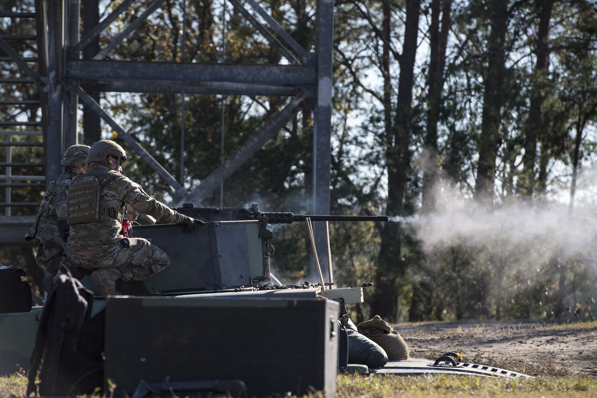 An Airman from the 823d Base Defense Squadron, fires a .50 Caliber M2 machine gun during a heavy weapons qualification, Dec. 13, 2017, at Camp Blanding Joint Training Center, Fla. Airmen shot at targets with the M2 to maintain their proficiency and familiarize themselves with the weapon. (U.S. Air Force photo by Senior Airman Janiqua P. Robinson)