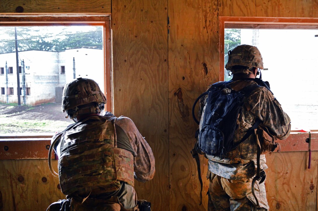 Two soldiers aim firearms out of windows.