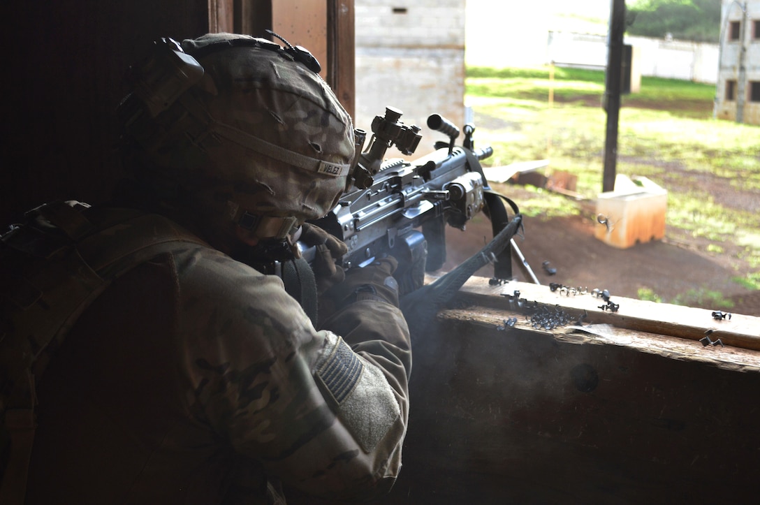 A soldier fires a weapon out of a window.