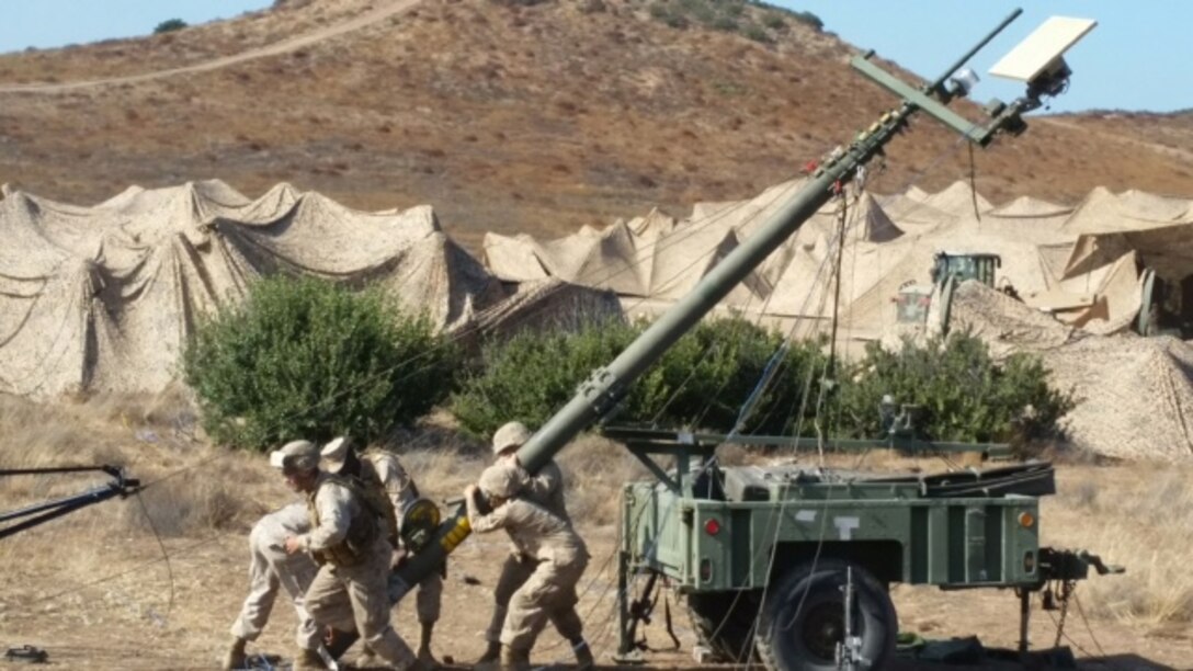 Marines from Bravo Company work as a team to set up a Tactical Elevated Antenna Mast System, or TEAMS, to establish line of sight microwave communications with the Battalion Main Element.