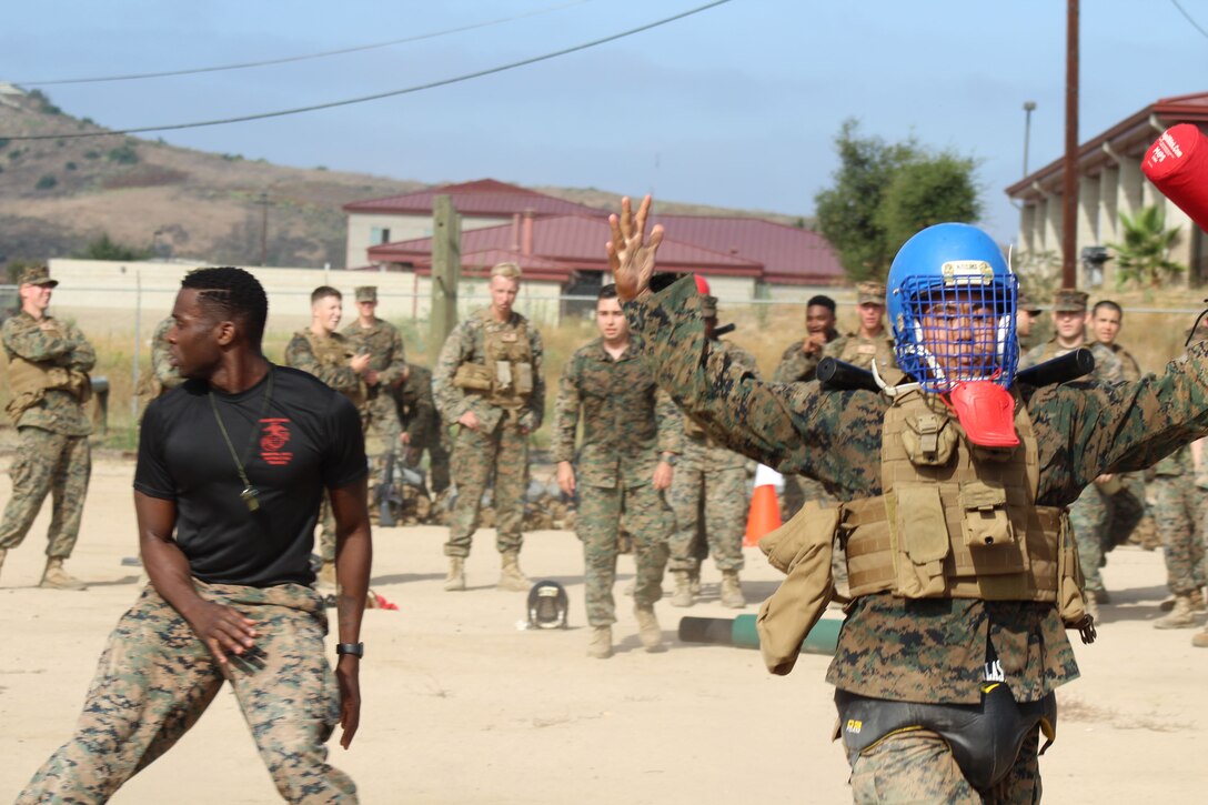 1stLt Oshiro walks away victorious after Sgt Rawlins declares him the winner during pugil sticks. The Marines of 9th Communication Battalion competed in a variety of MCMAP contests to include pugil sticks and ground fighting following a 6 mile gas hike.