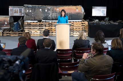 The U.S. ambassador to the United Nations stands in front of evidence during a news conference.