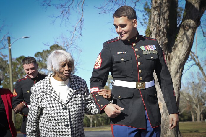 A Marine escorts a guest in to the 48th annual Senior Tea aboard Marine Corps Air Station Beaufort, Dec. 11. The time honored event began in 1968. Since then the event has been held to honor one of Team Beaufort’s greatest generations. The Marine is stationed aboard MCAS Beaufort.