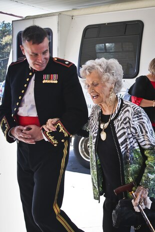 Lt. Col. Adam Jeppe escorts a guest during the  48th  annual  Senior  Tea  aboard  Marine  Corps  Air  Station  Beaufort,  Dec.  11.  The  time  honored  event  began  in  1968.  Since  then  the  event  has  been  held  to  honor  one  of  Team  Beaufort’s  greatest  generations.  Jeppe  is  the  commanding  officer  of  Marine  Aviation  Logistics Squadron 31.
