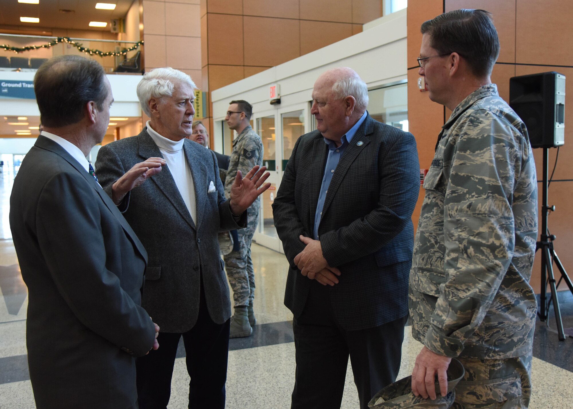 Thomas E. Simmons, author, speaks with Billy Hewes, Gulfport mayor, (left), retired Brig. Gen. Joe Spraggins, Mississippi Department of Marine Resources executive director, and Col. C. Mike Smith, 81st Training Wing vice commander, during the Gulfport-Biloxi International Airport 75 Year Commemoration Dec. 13, in Gulfport, Mississippi. A historical marker at the entrance of the airport was unveiled by local dignitaries during the event honoring the airport’s ties to the military dating back to 1942. (U.S. Air Force photo by Kemberly Groue)