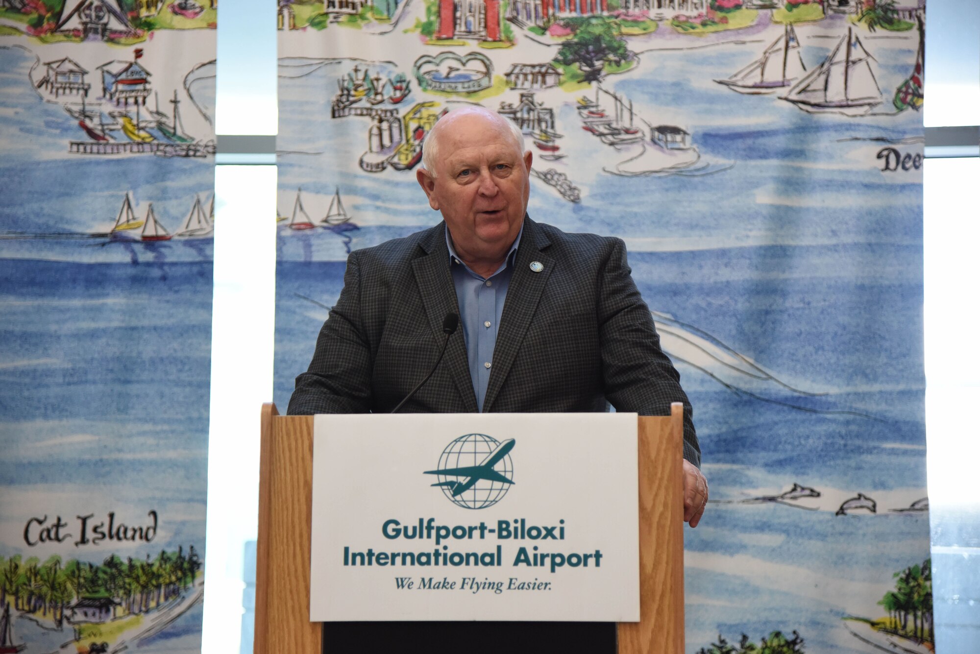 Retired Brig. Gen. Joe Spraggins, Mississippi Department of Marine Resources executive director, delivers remarks during the Gulfport-Biloxi International Airport 75 Year Commemoration Dec. 13, in Gulfport, Mississippi. A historical marker at the entrance of the airport was unveiled by local dignitaries during the event honoring the airport’s ties to the military dating back to 1942. The U.S. Air Force Band of the West, Nightwatch, also performed during the event. (U.S. Air Force photo by Kemberly Groue)